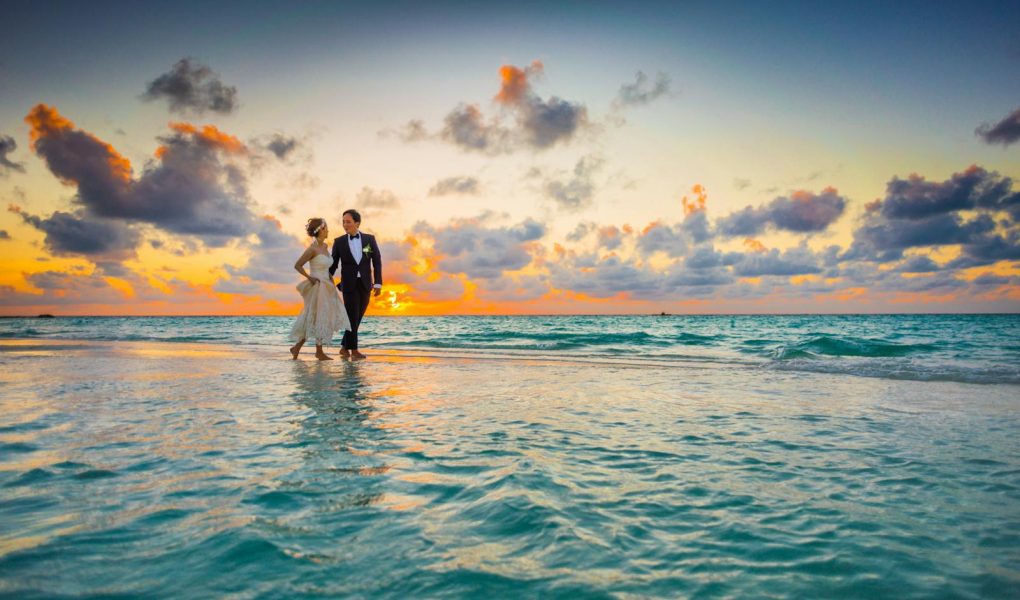 Man and Woman Walking of Body of Water