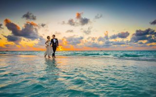 Man and Woman Walking of Body of Water