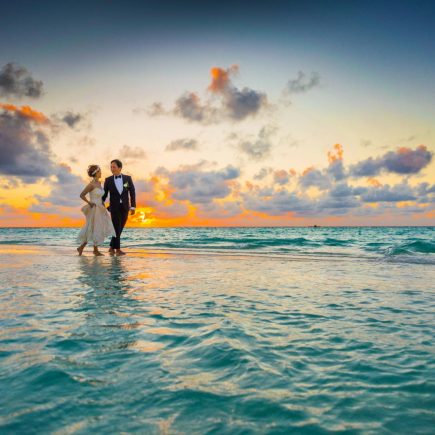 Man and Woman Walking of Body of Water